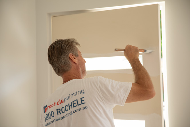 interior house painter painting the front door
